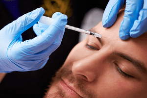 Botox Being Injected into a mans forehead | Stratum Dermatology Clinics